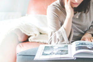 woman looking through a photo album